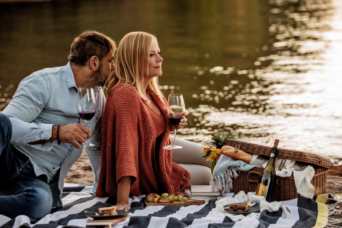 Anita and Dario having a picnic by the river